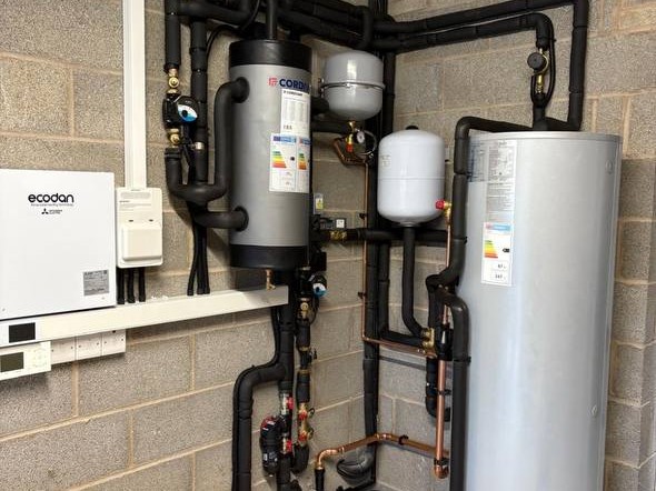 Indoor air source heat pump plant room installation with pipework